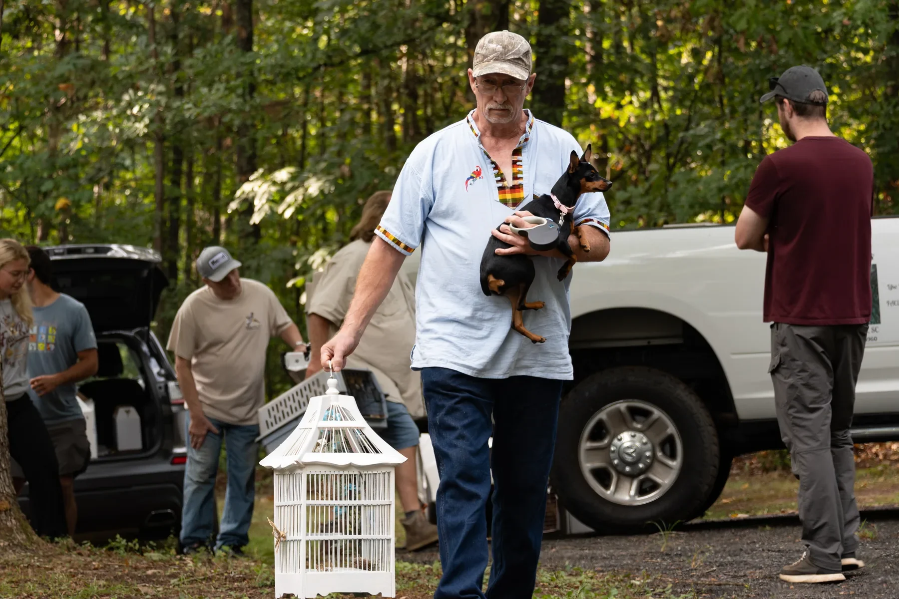 GGBBA member carrying an aviculture transport cage outdoors